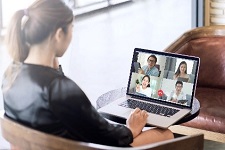 Virtual meeting on laptop screen.